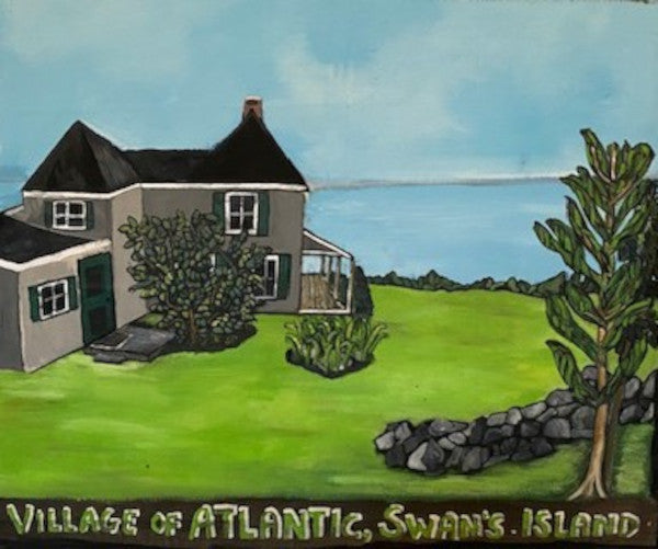 A gray seaside cottage sits on a lime green lawn next to the blue ocean. A stone wall and tree complete the picture,