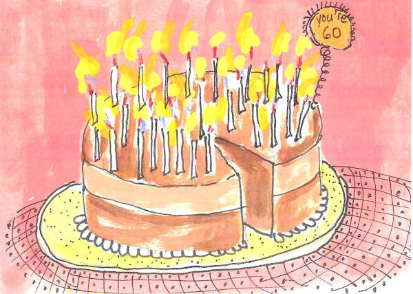 Amid a pink background and tablecloth sits a magnificent chocolate cake. There are many candles lit and they light up the placard that reads You're 60!