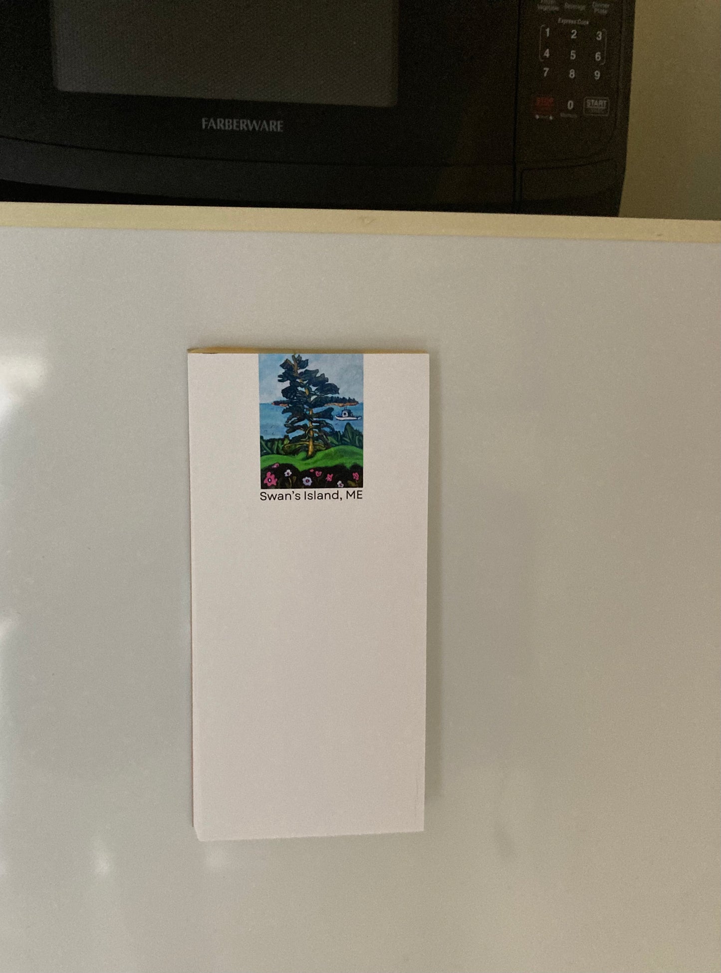 Mockup of Swan's Island Magnetic Notepad on a refrigerator.