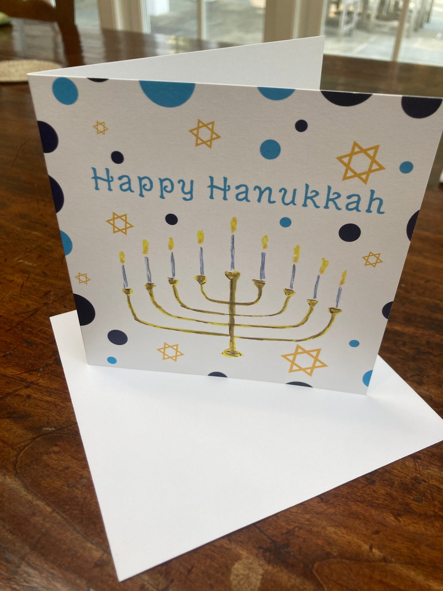 Hanukkah card with Menorah design on a wooden surface