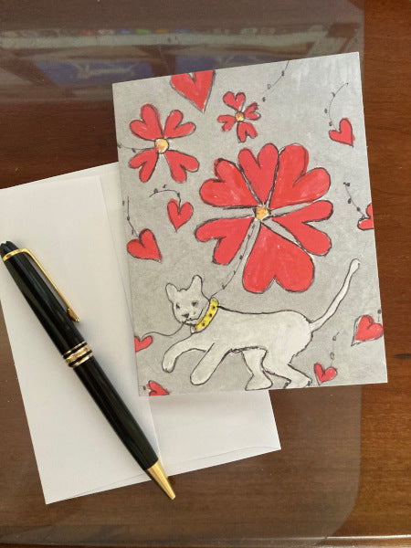 Photograph of the card titled Made Just For You shown lying on a brown desk top with partial view of white envelope and a black fountain pen.