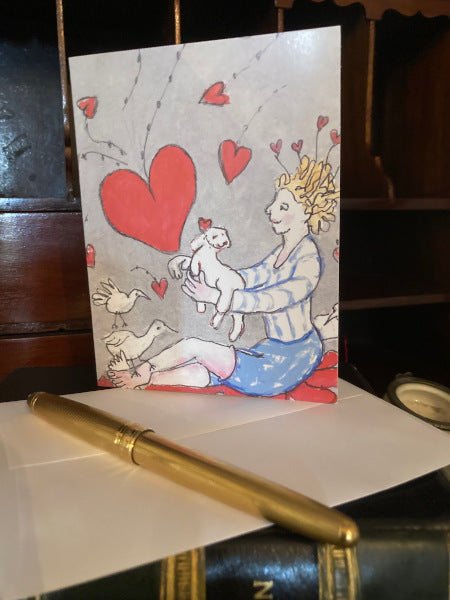 Photo of the front of the card Just for You on a brown desk with a white envelope and a gold colored pen.