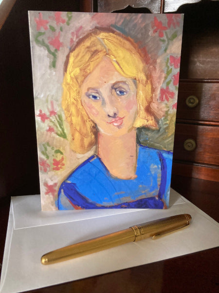 Mockup of portrait girl greeting card front and envelope displayed atop a wooden desk