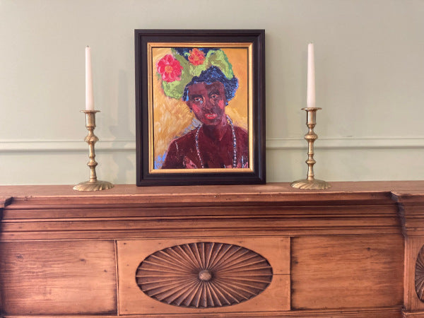 Mockup of the portrait on a decorative wooden mantelpiece.