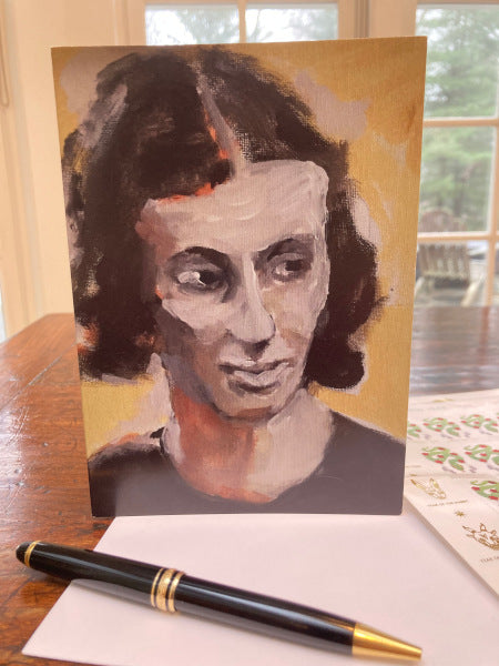 Mockup of the card on a wooden table which compliments the ochre background in the painting.