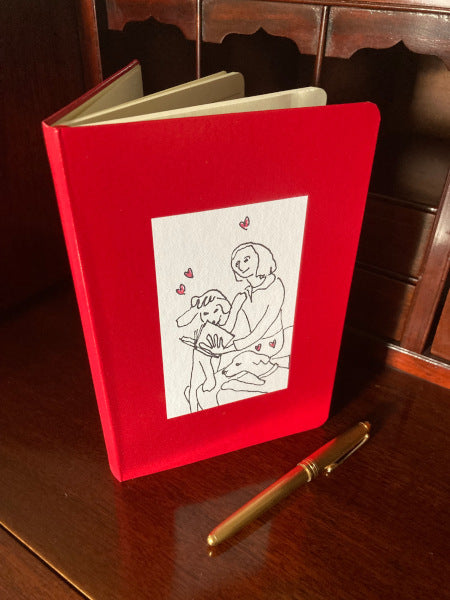 On Being Idolized journal book printed on red standing on a desk with the front cover showing.