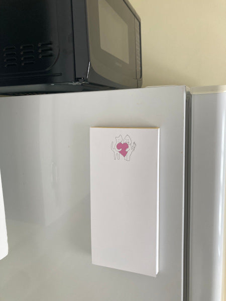 Sharing A Big Heart magnetic notepad on a refrigerator.
