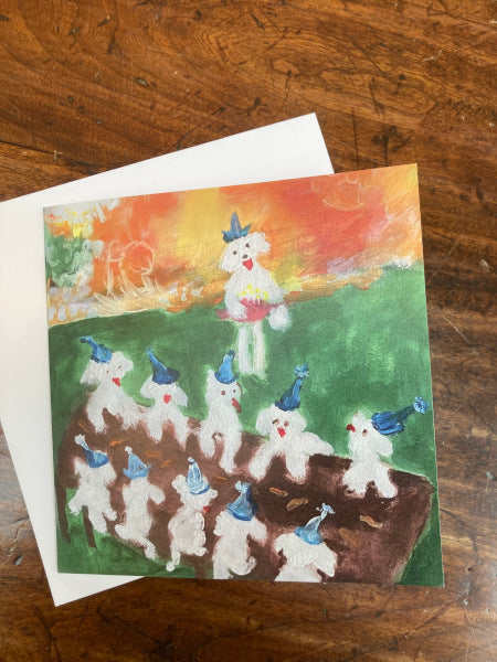 The front of this joyful birthday card, Birthday Picnic, shows little white Maltese dogs in party hats at a picnic table.