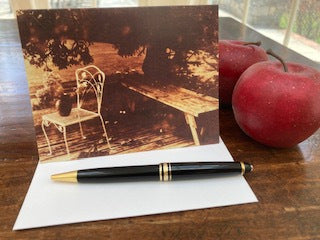 Mockup of the card is on a wooden table next to two red apples.