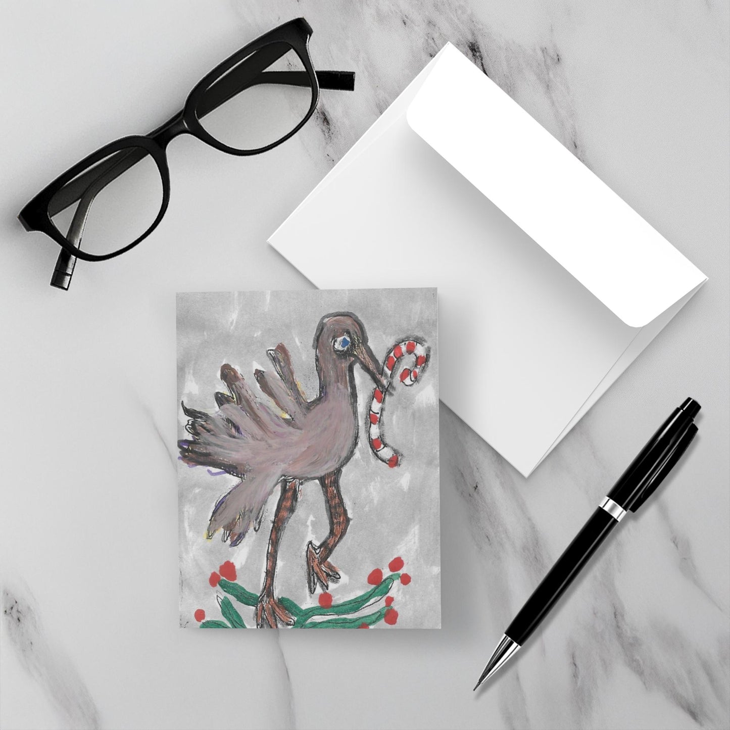 mock up of front of the card with its envelope on a white marble surface.