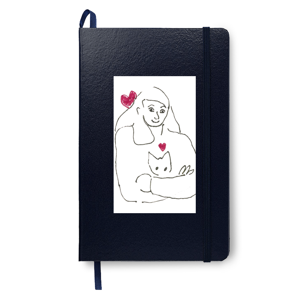 This mockup shows Armful of Love on a navy journal. The sweetness of the black and white drawing of a girl embracing her cat is highlighted by two red hearts.