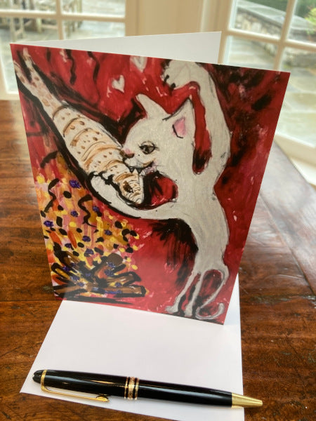 Mockup of Firepit Fun greeting card standing up on a wooden table. The envelope and a pen are also included.