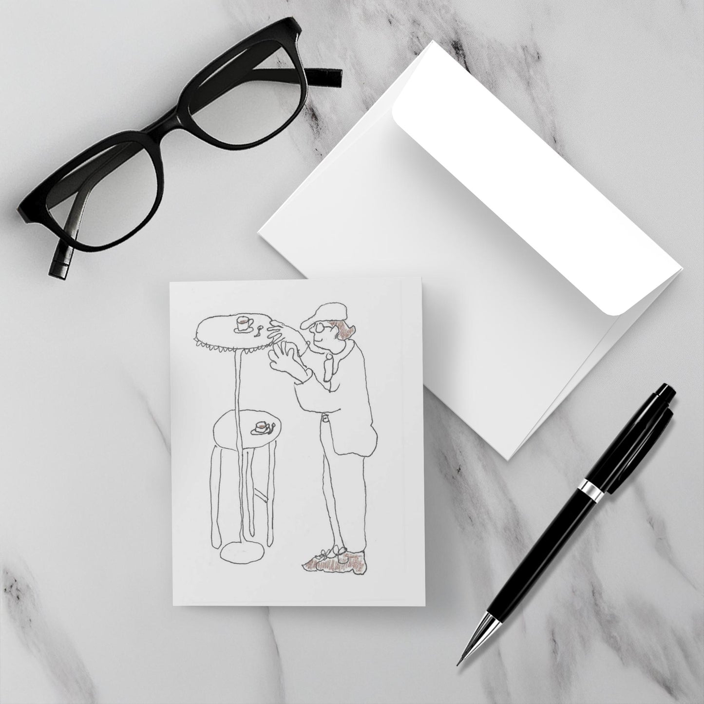Mockup of the front and back of the greeting card titled High Top Table For Daddy lying on a grey marble surface with envelope and black pen and pair of black reading glasses