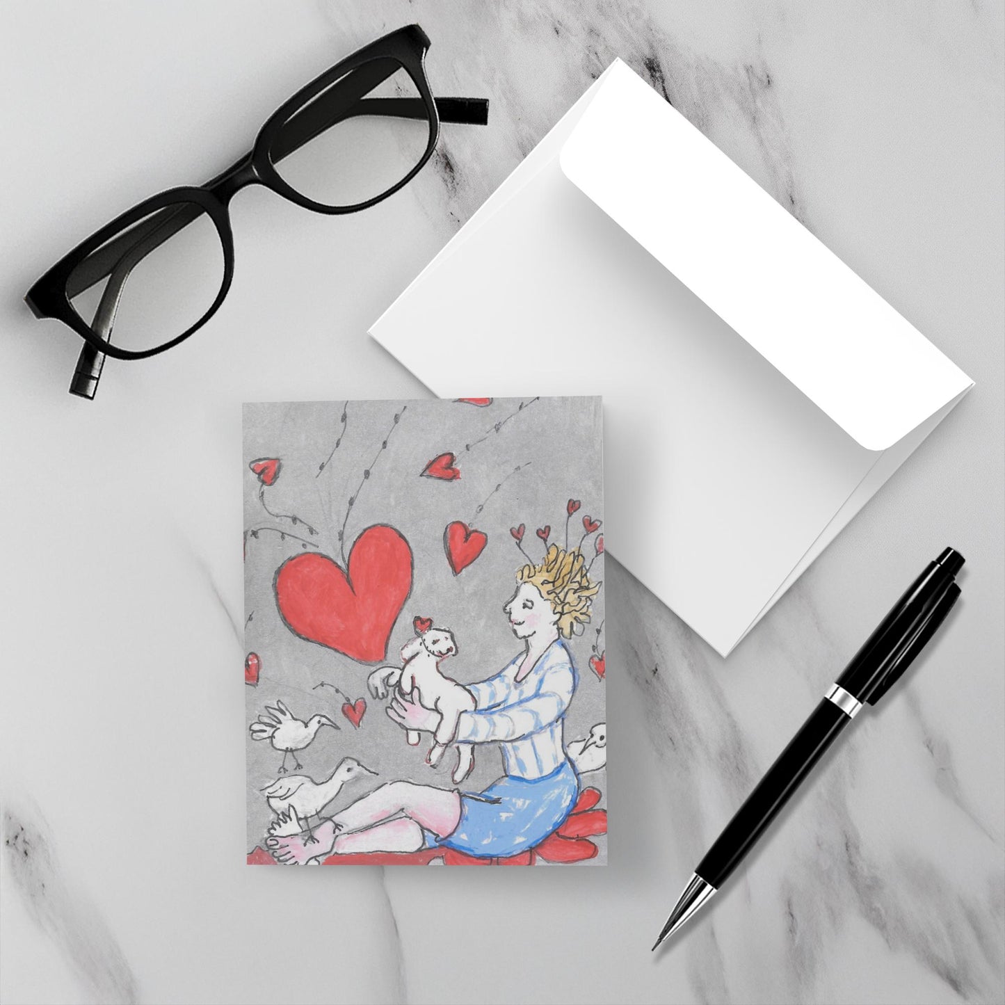 Mockup display showcasing the front of the greeting card Just For You lying on a gray marble surface along side a white envelope, a pair of black reading glasses and a black pen.