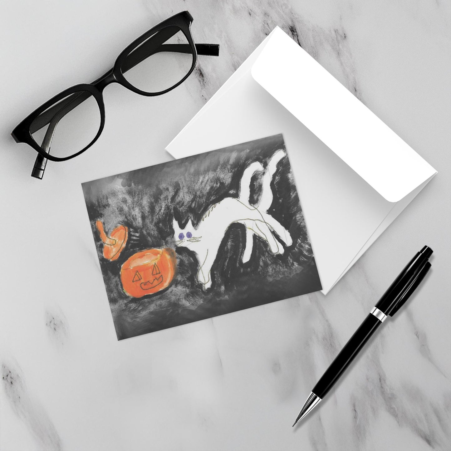 Mock up of the orange, black and white Halloween card with its envelope,