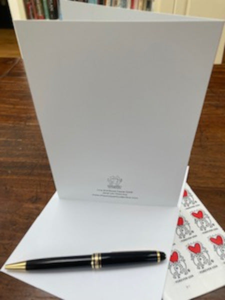 Mock up of the back of the card along with some stamps and the envelope,