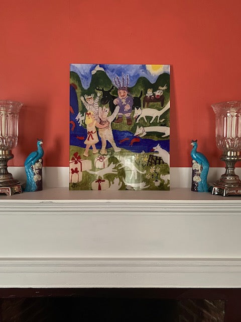 Party Time acrylic art print is shown photographed on mantle with objets d'art flanking it to give perspective. The print is a colorful depiction of imaginative party where guests are human and animal and are scene frolicking in outdoor scene of green snowcapped mountains and blue flowing river with orange fish..