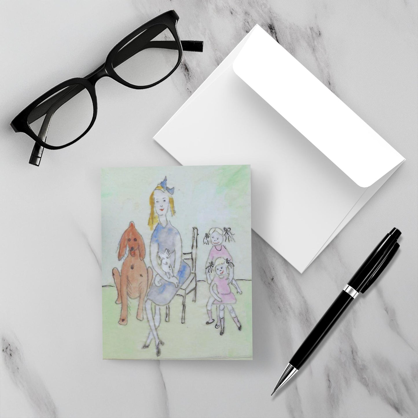 Mockup display showcasing the front of the greeting card Mother's Day lying on a gray marble surface along side a white envelope, a pair of black reading glasses and a black pen.
