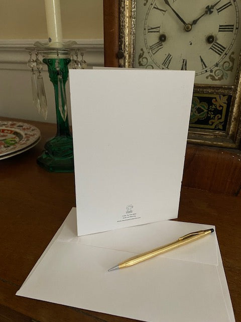 Mockup of the back of Under The Tree Christmas card and envelope showing the title of the card and the Chauncey Art Collective logo.