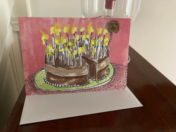 Mock up of the birthday card You're 30 along with it's envelope sitting on a wood table.