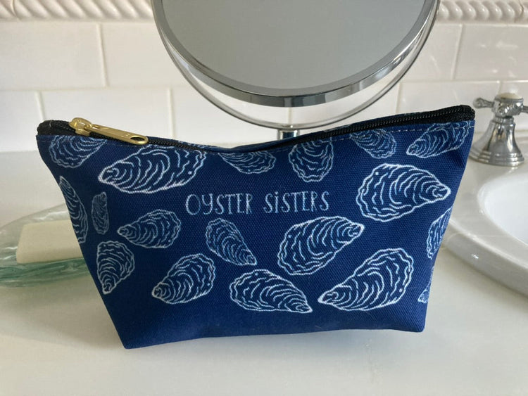 Accessory Pouch in navy with white oyster shells and the words OYSTER SISTERS