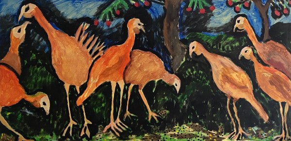 A gaggle of Turkeys are feasting on seeds that they have found on the forest floor, 