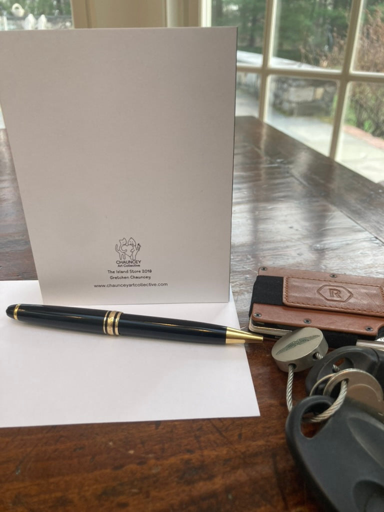 White card with a logo on a wooden surface next to a pen and keys.