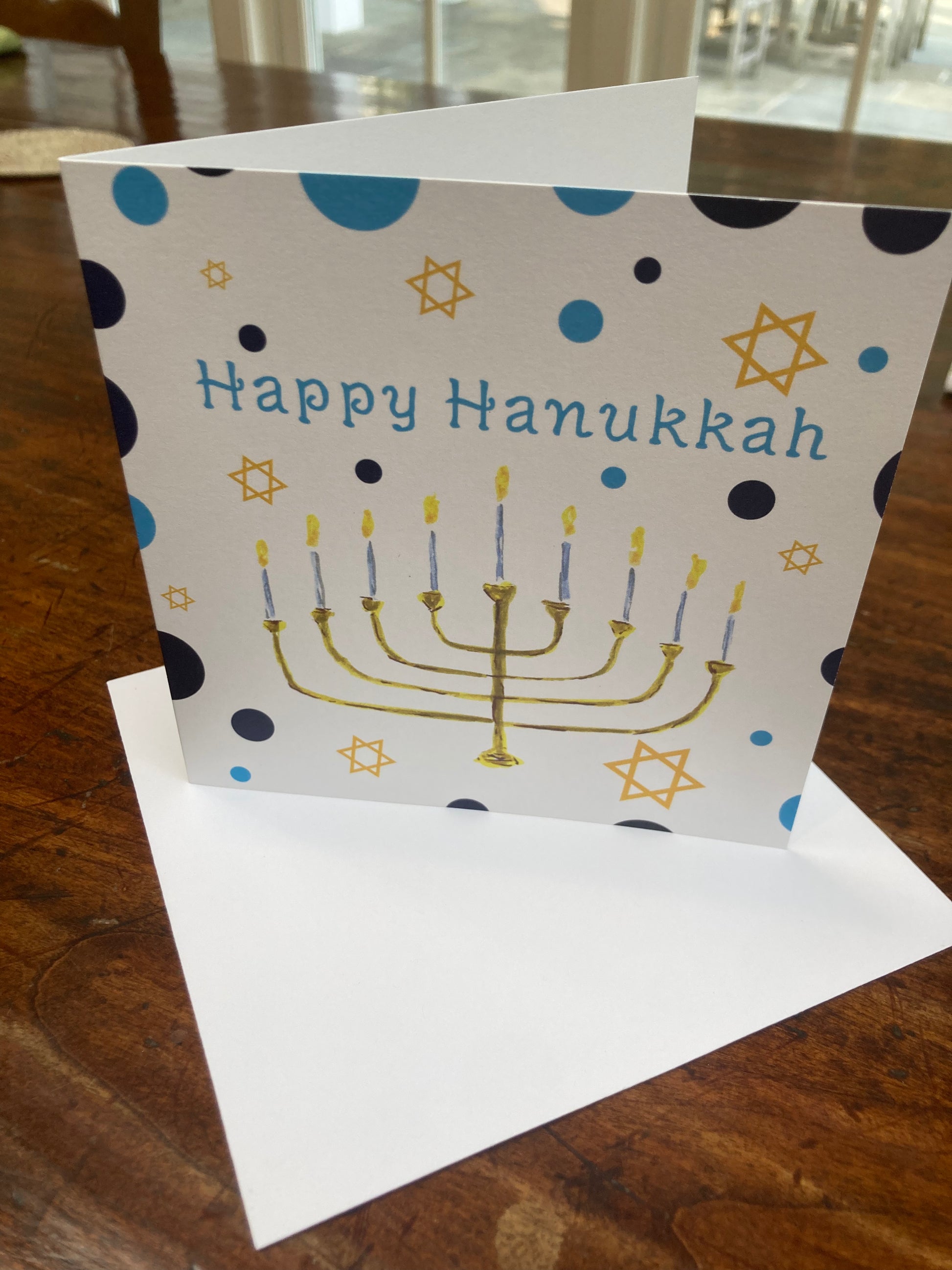 Hanukkah card with Menorah design on a wooden surface