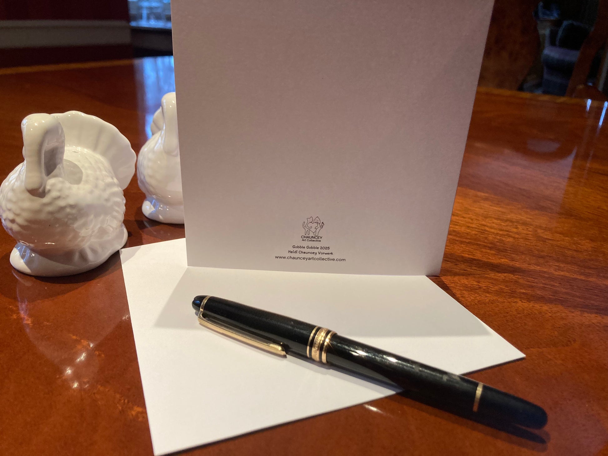 Fountain pen on a card with a logo on a wooden surface