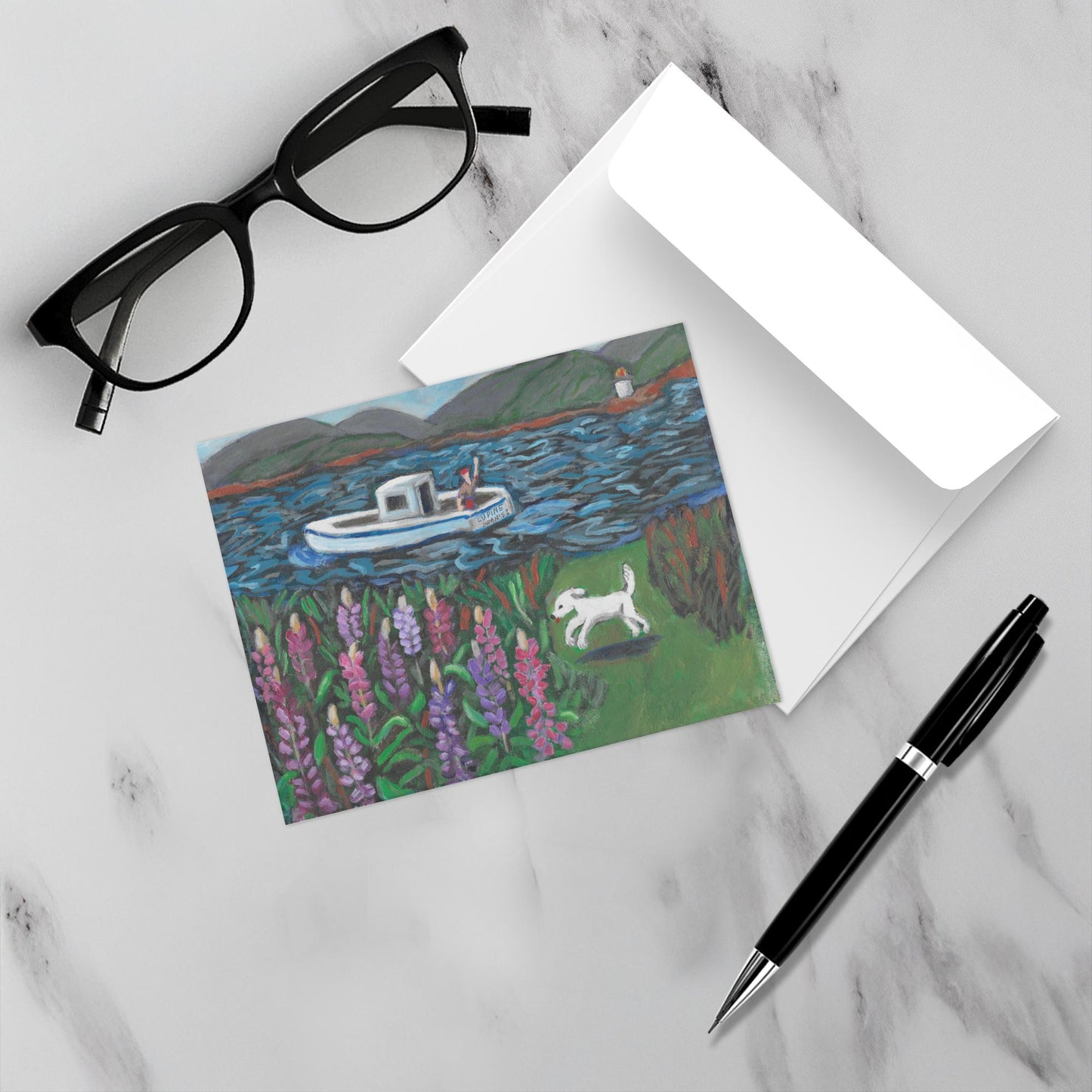 Island Lupine Time Swan's Island notecard sits on a marble surface near a pen, eyeglasses and an envelope.