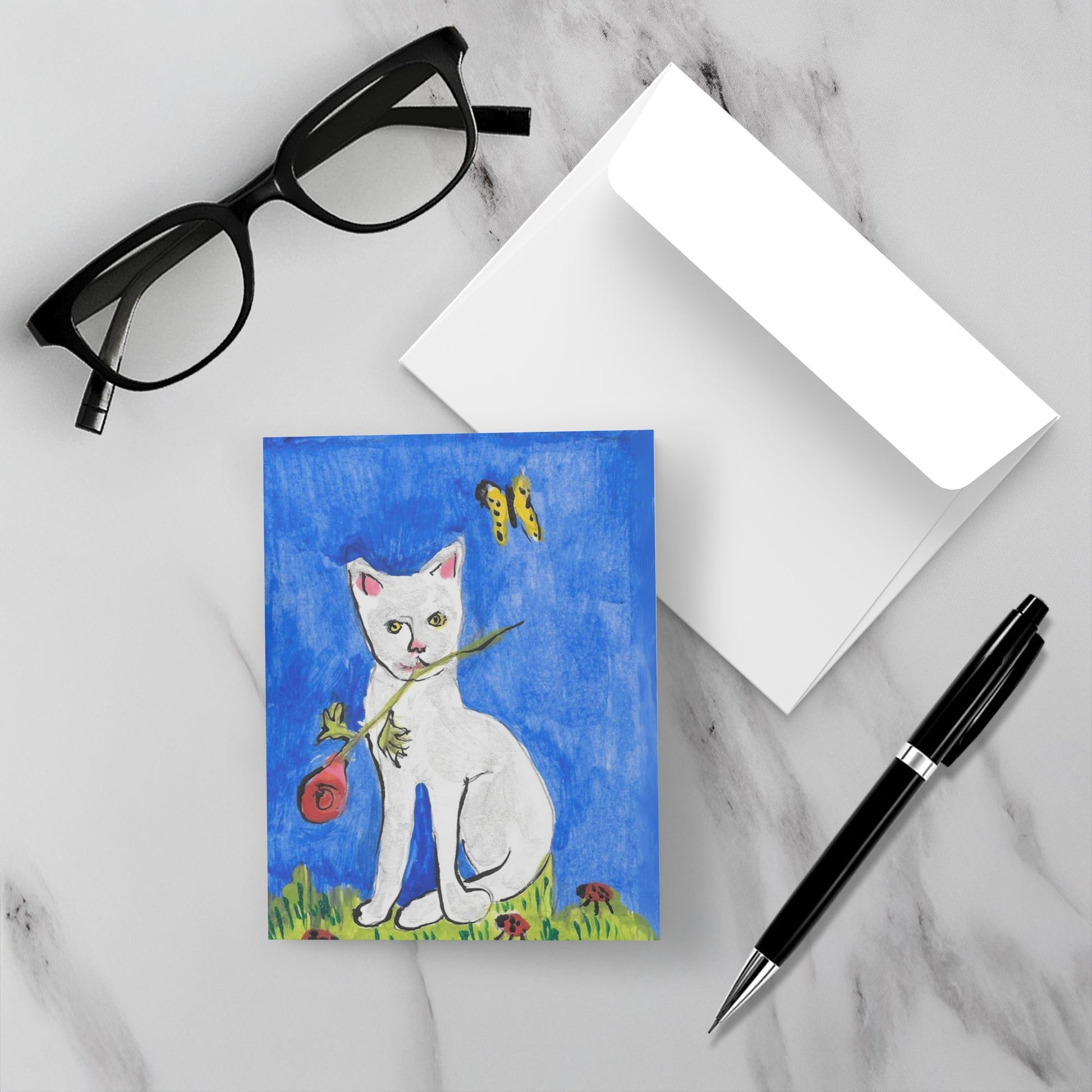 Caspar And Suddenly Feline Greeting Card: A white cat sitting in the grass with ladybugs, holding a red rose in its mouth while a yellow butterfly flutters against a bright blue background. High-quality reproduction of original acrylic on paper by Janet Lee Chauncey for Chauncey Art Collective.