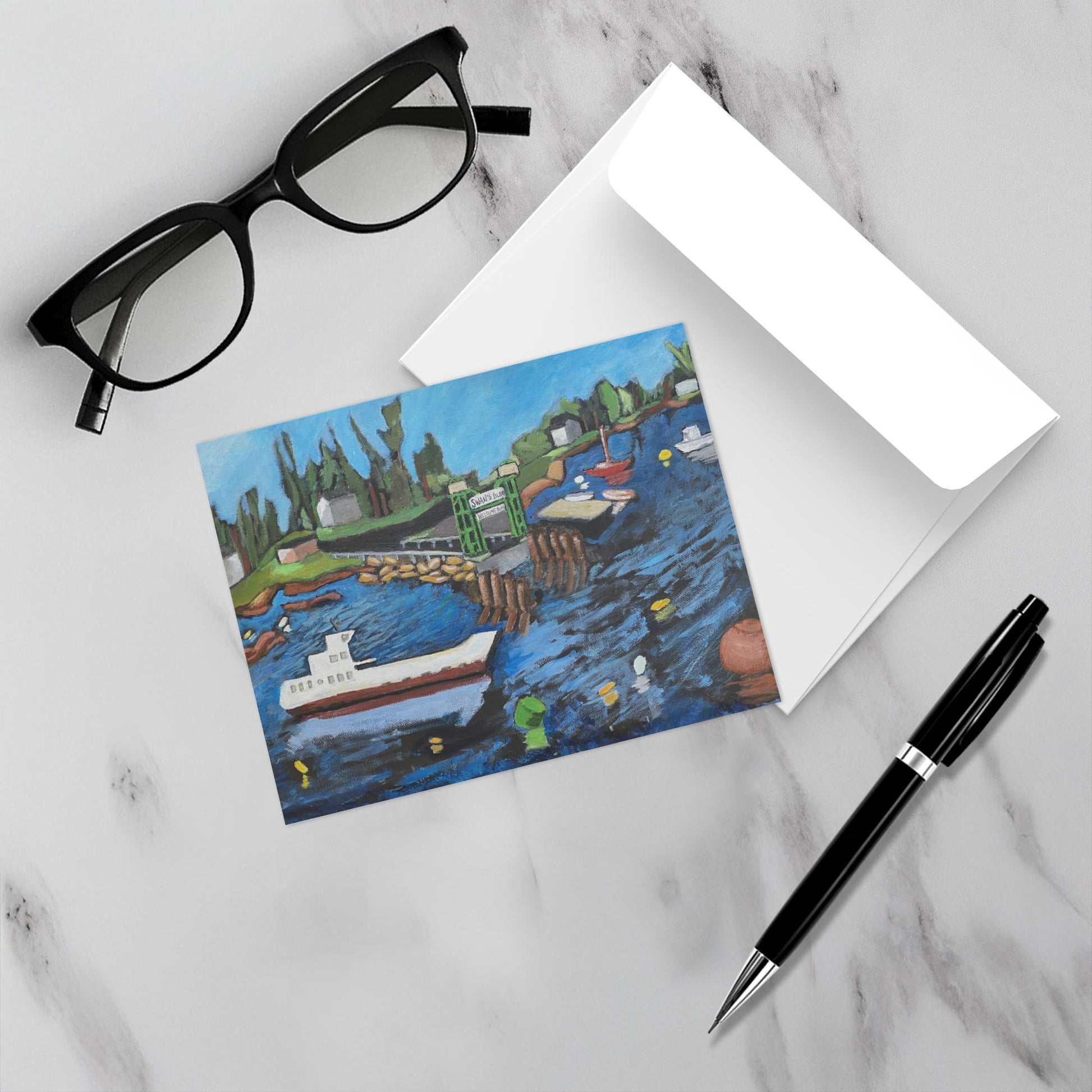You have Arrived notecard on a marble surface with envelope, pen and eyeglasses. 