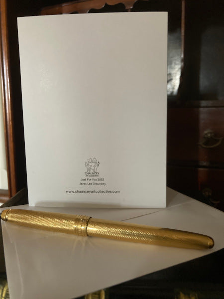 Photo of the back of the greeting card Just For You showing the Chauncey logo and the card title, with a white envelope and a gold pen.