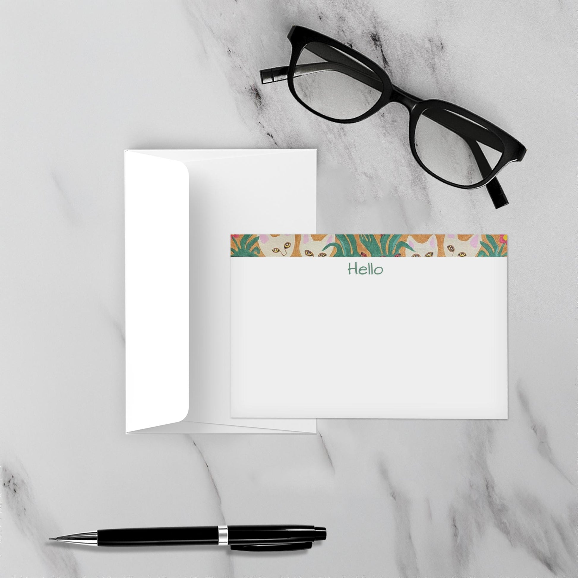 Note card with floral design and Hello text on a marble surface with glasses and pen.