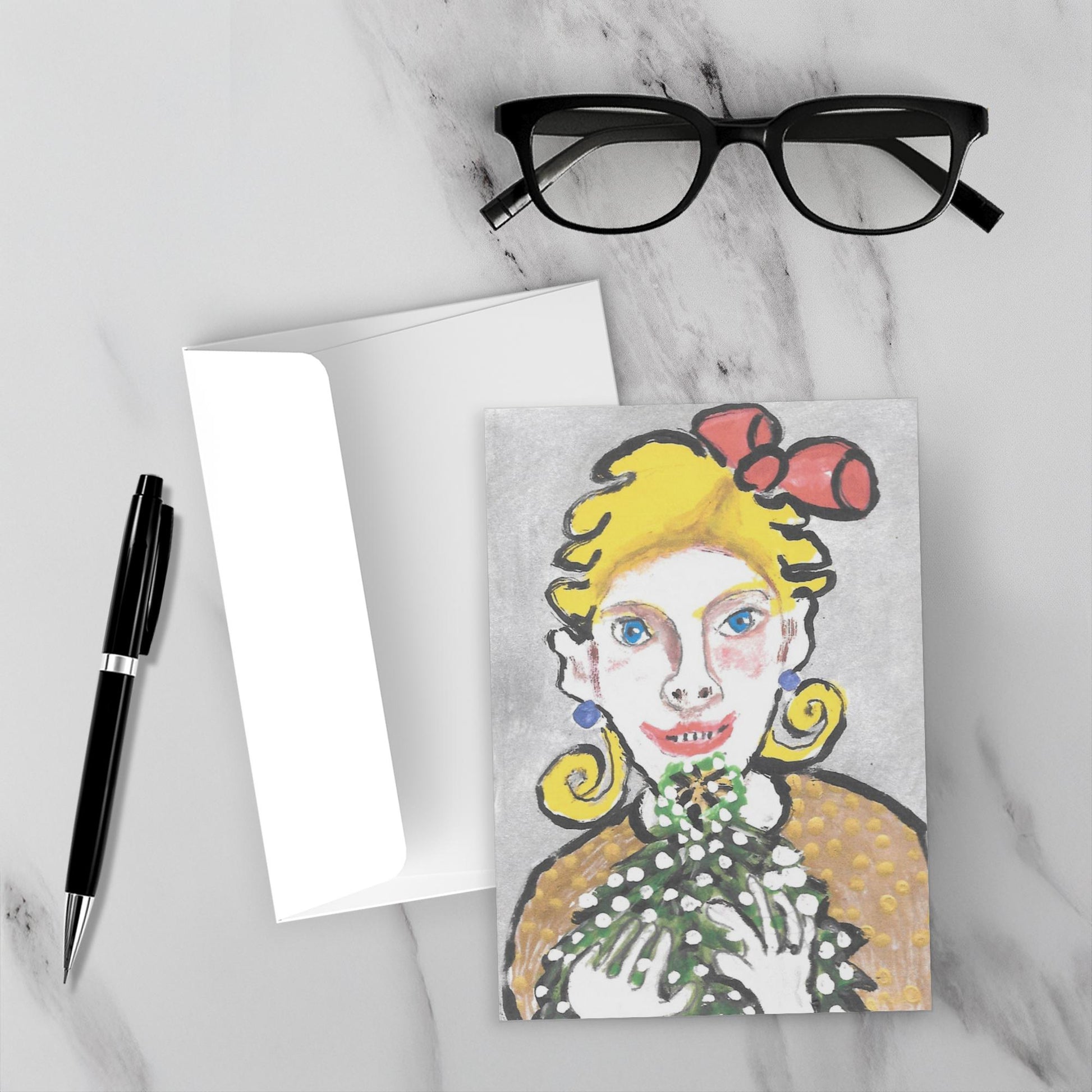 Mockup of A Beautiful Feeling Christmas card on a white marble background with its envelope and a black pen and reading glasses.