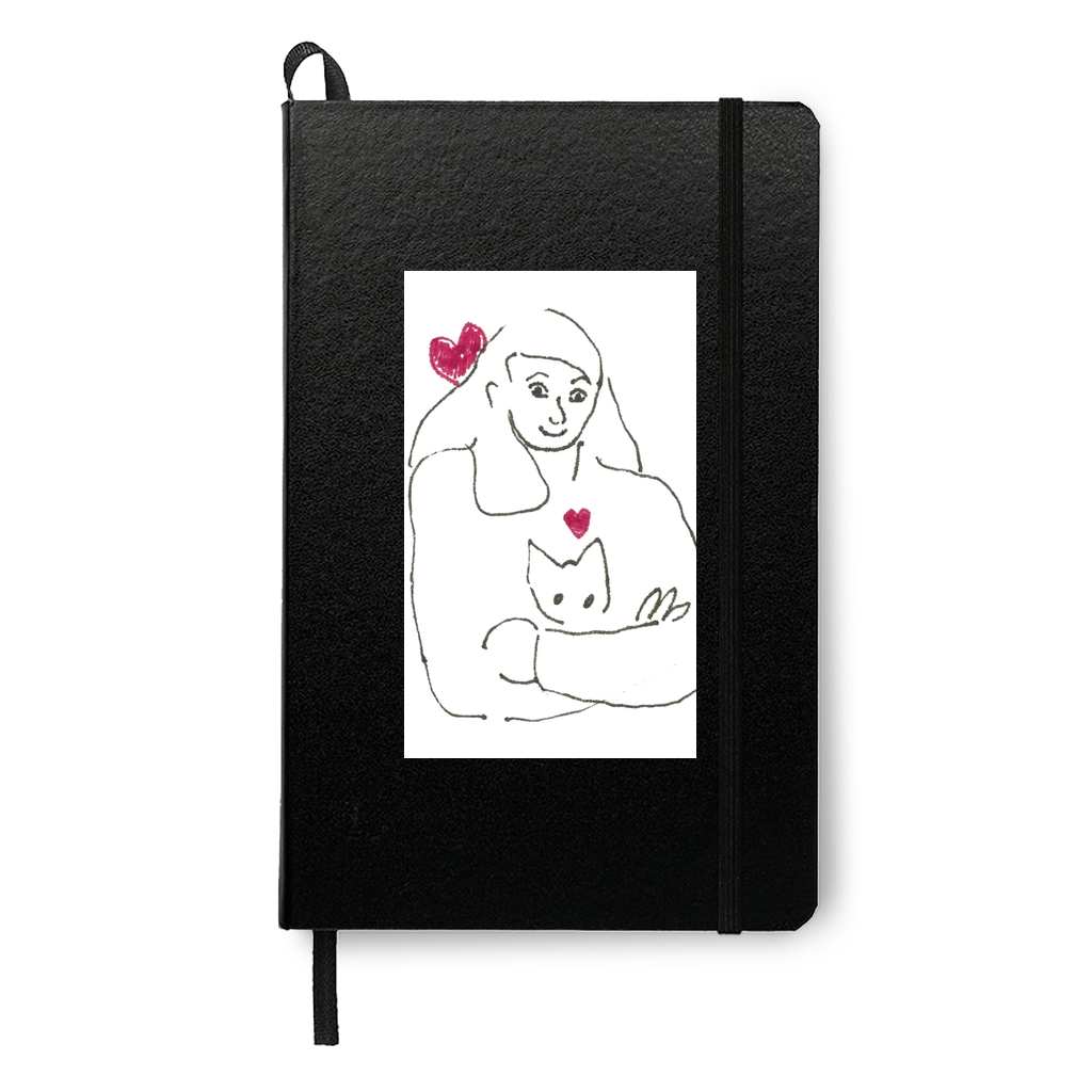 Mockup of Armful Of Love Journal printed on a black journal. The dark color background highlights the sweet drawing of a girl with her cat.