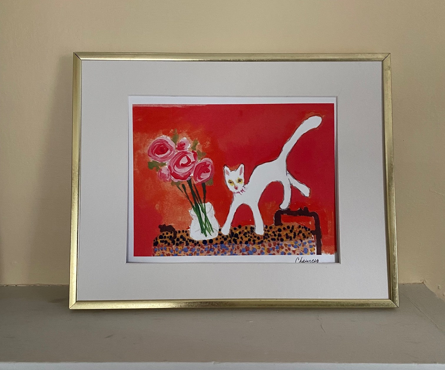 Placed in a gold frame with white matting Caspar With Roses colors really come alive. The orange background pops as does the white cat who has jumped on the table. The vase of pink roses is next to the cat.