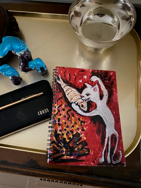 Mockup of Firepit Fun! spiral notebook where the colorful notebook stands out against a golden tray background.