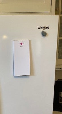 Chauncey Art Collective magnetic notepad is hanging on a white refrigerator in this mockup.