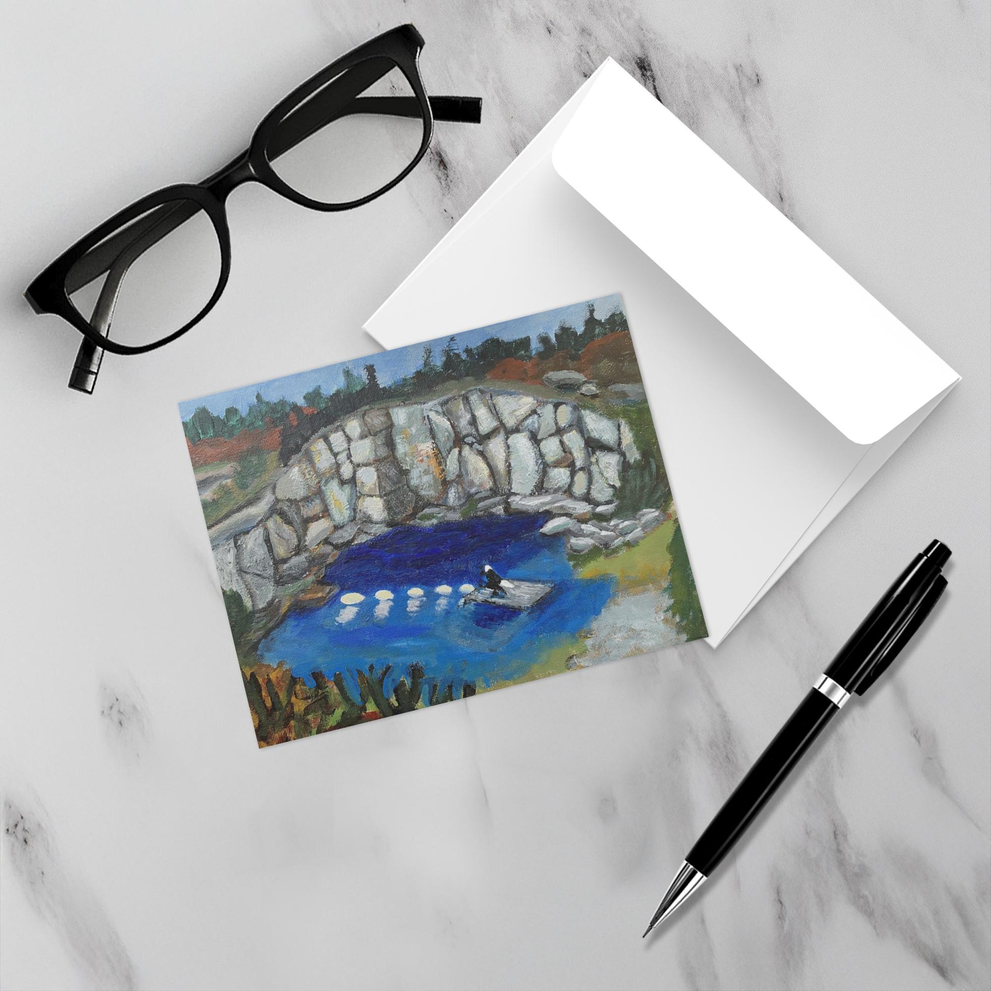 Eagle on Duty notecard on a white marble surface with a pen, glasses and its envelope.