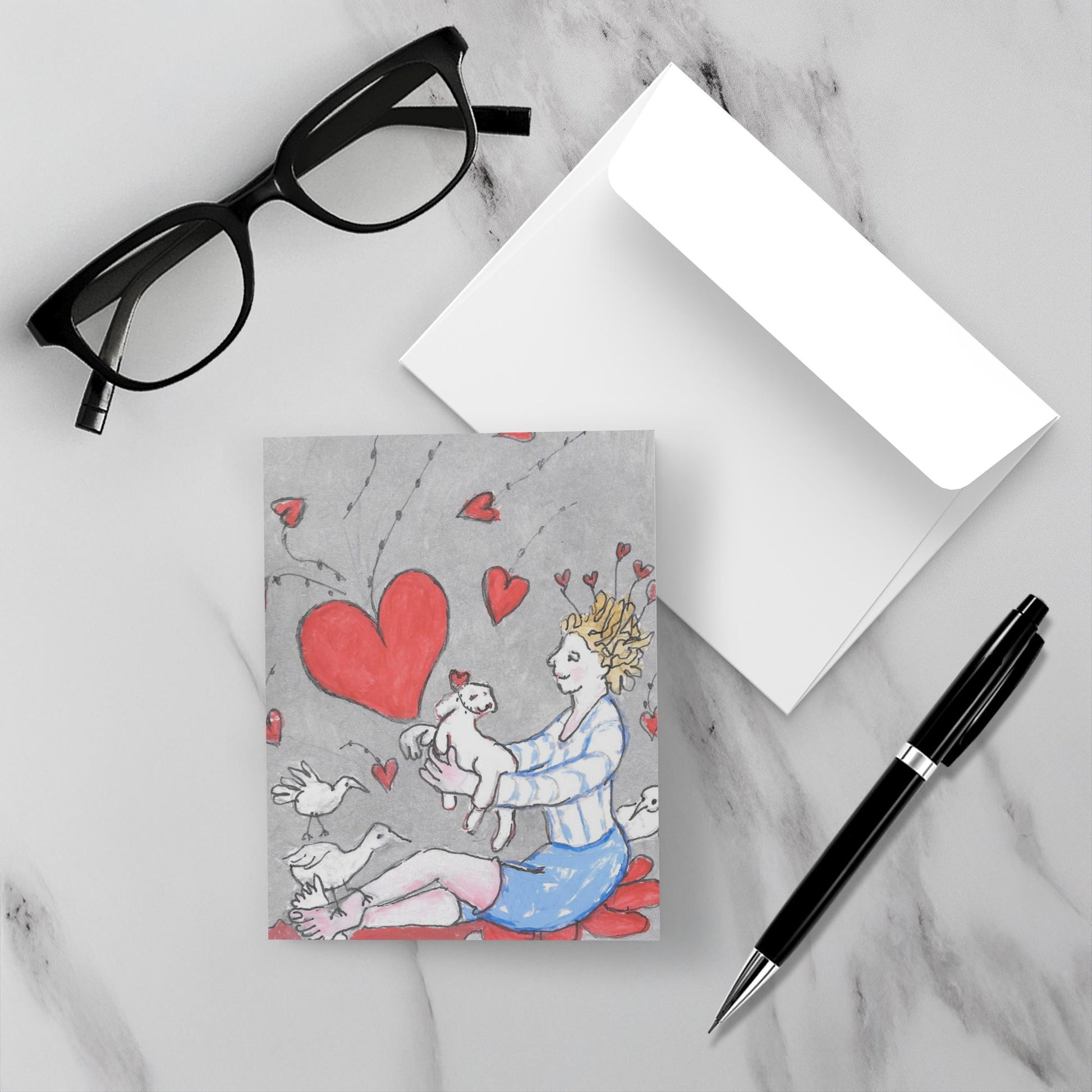 Mockup display showcasing the front of the greeting card Just For You lying on a gray marble surface along side a white envelope, a pair of black reading glasses and a black pen.