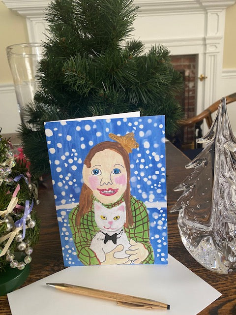 Christmas card with a girl and a on a table with decorative items