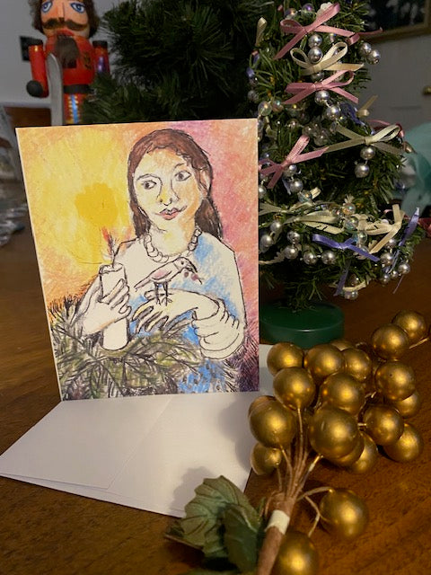 Mock up of the Christmas card ,Candle Glow, displayed on a table, by Chauncey Art Collective.