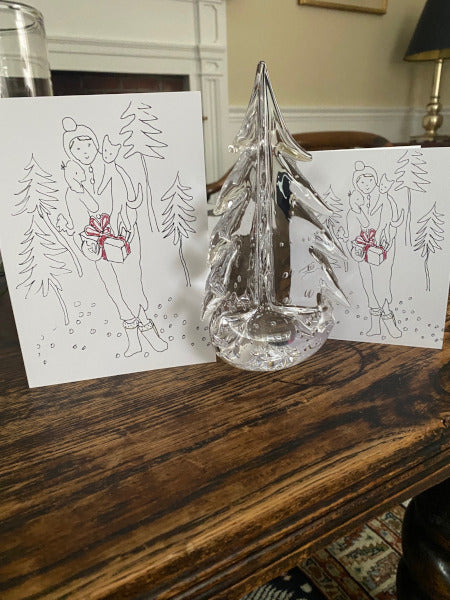 Holiday Delivery cards on tabletop with glass tree