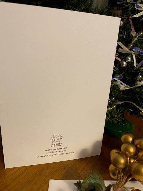White card with a logo and text on a wooden surface with Christmas decorations.