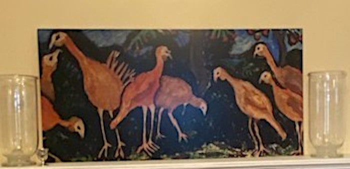 Mockup of Turkey Talk metal art print.  The metal print is on a white mantlepiece with two glass hurricanes on either side.