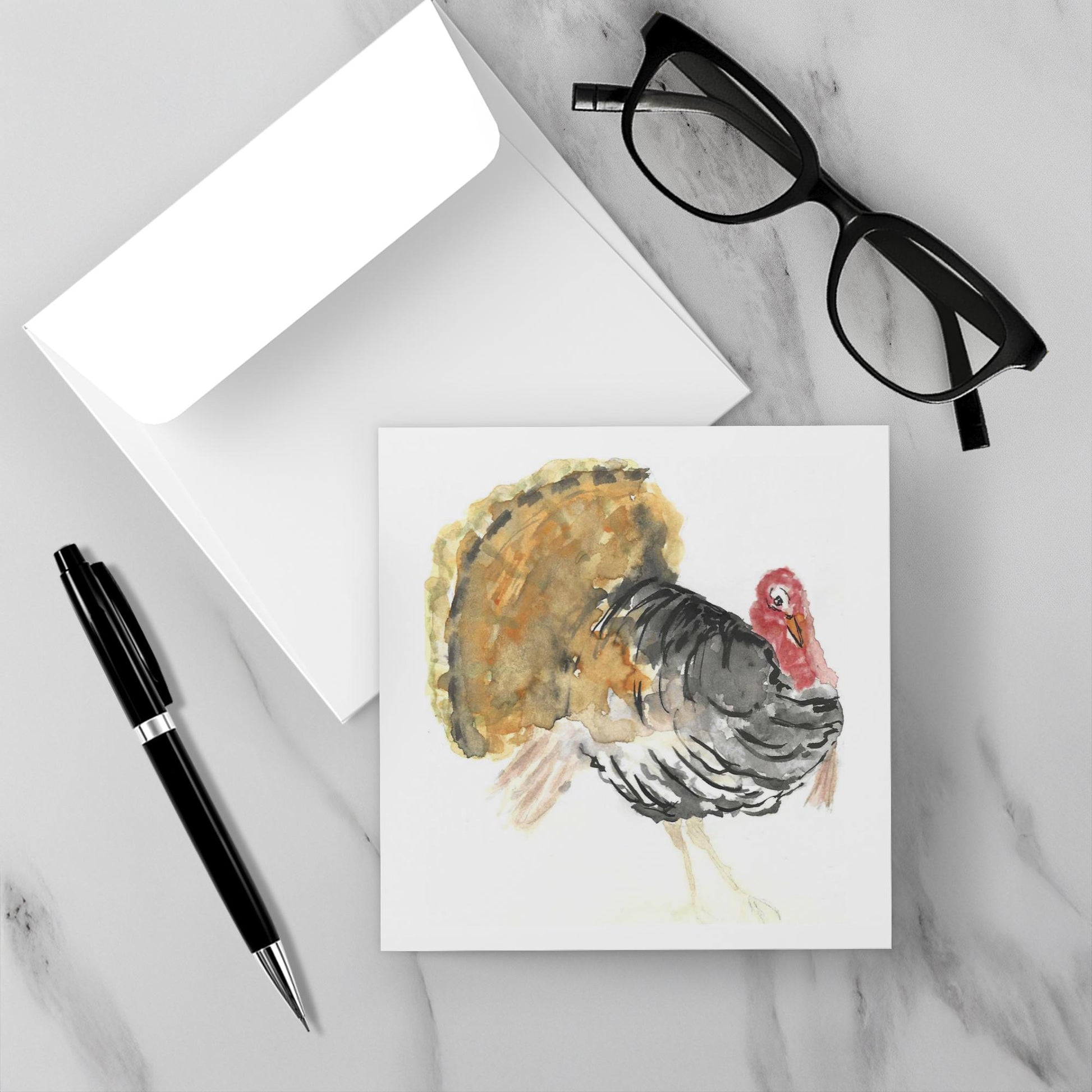 Card with a turkey illustration on a marble surface with glasses and a pen.
