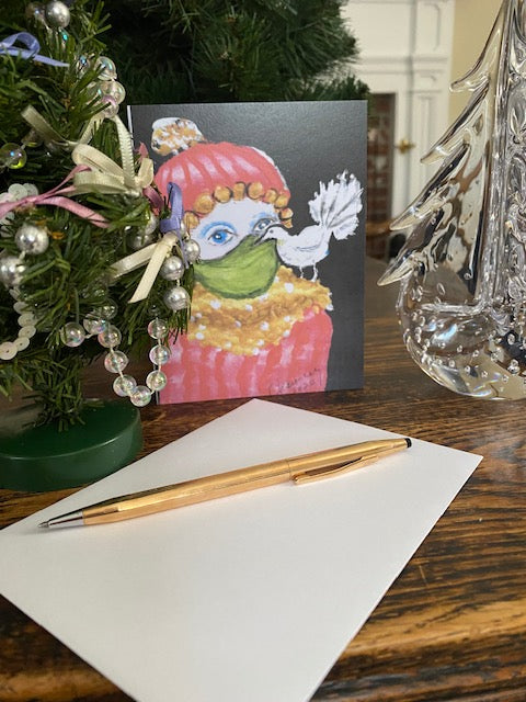 Decorative card with a colorful illustration of a character, pen, and envelope on a wooden surface.